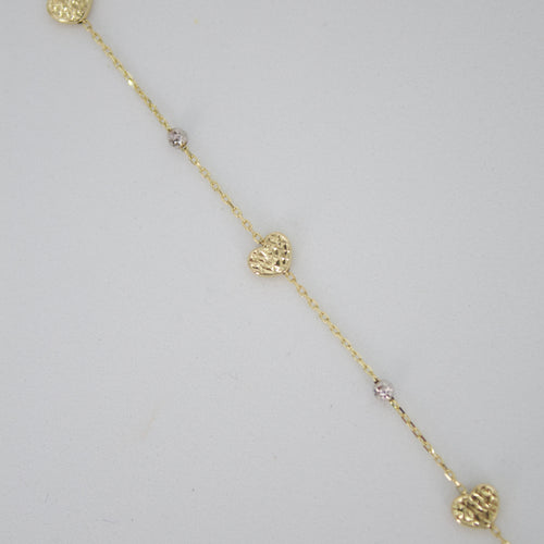 Pulsera corazones en oro combinado 14k.