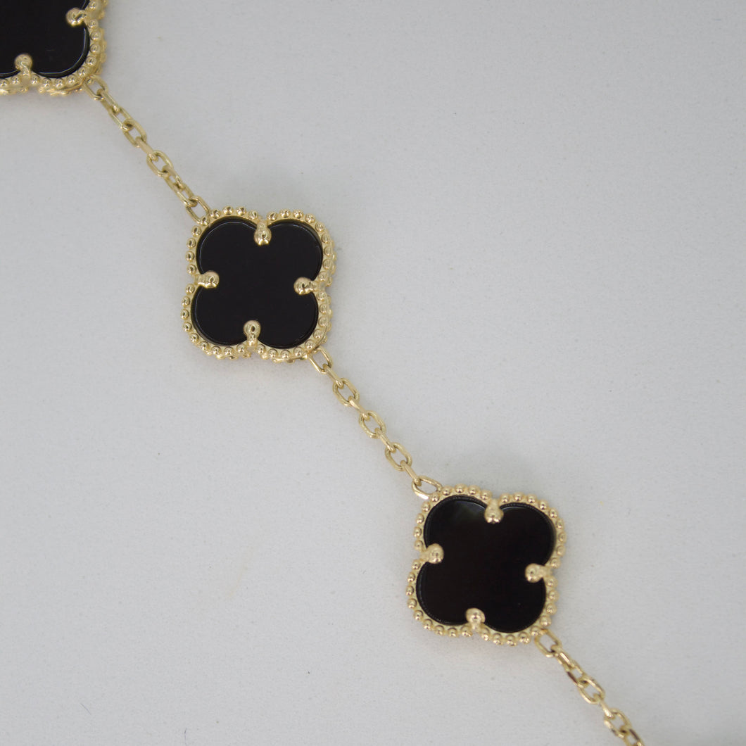 Pulsera trébol en oro amarillo 10k con onix.