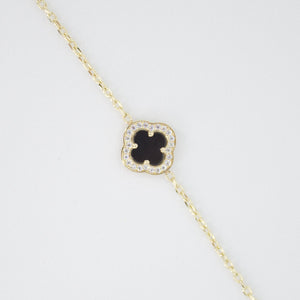 Pulsera trébol en oro amarillo 14k con ónix.