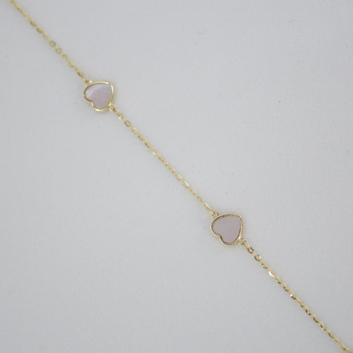 Pulsera corazones en oro amarillo 14k con perla.