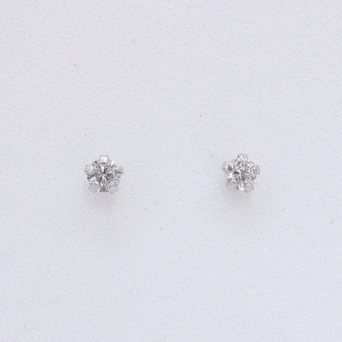 Broquel en oro blanco 14k con zirconia.